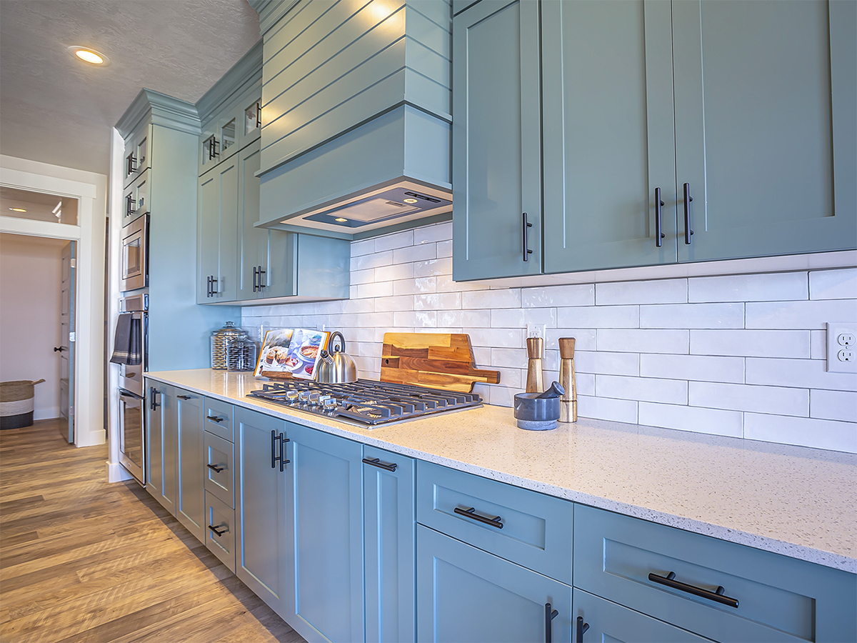 Kitchen with white countertop and bluish gray cabinets